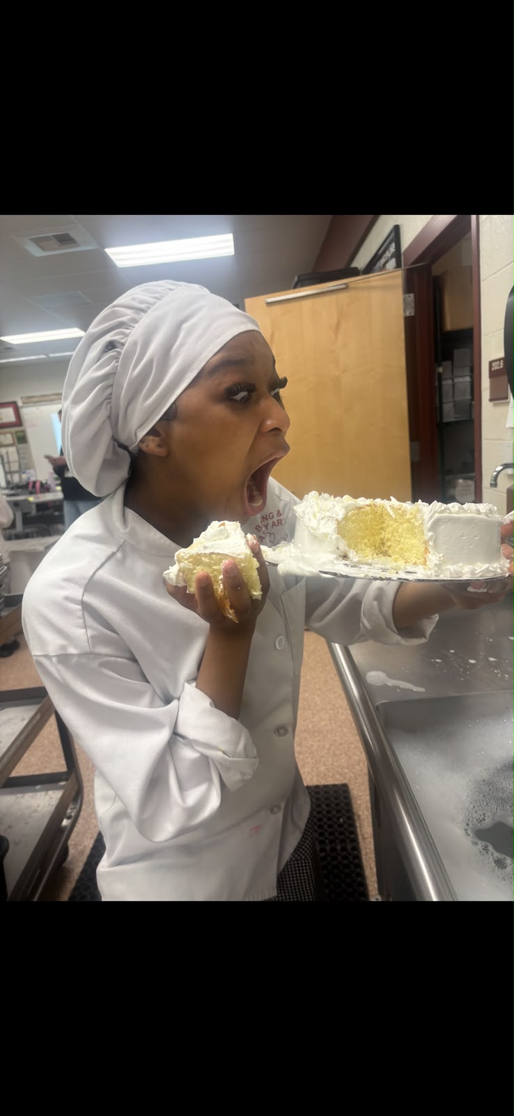 Anayah Gabrielle Wilkins sharing a joyful moment with a freshly baked cake